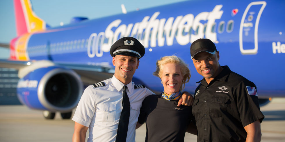 Pilots and fly attendant in front of Southwest aircraft