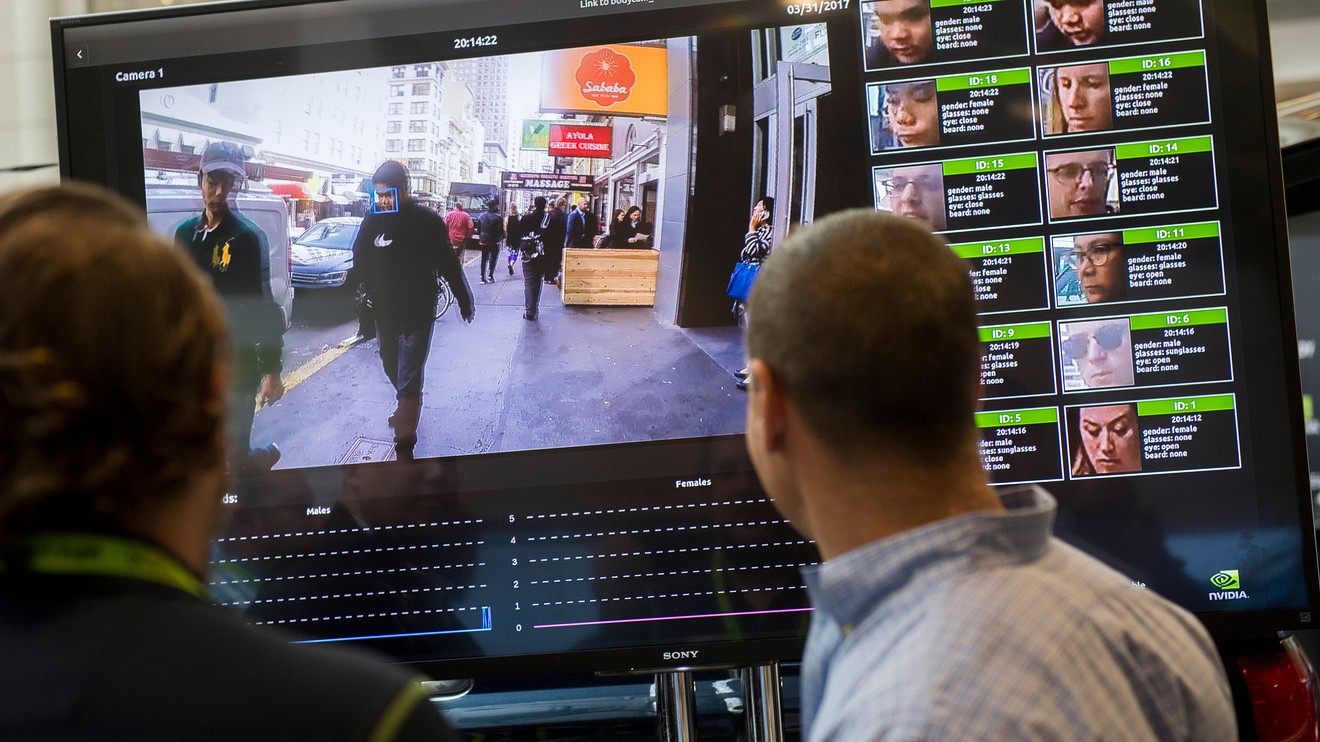 A man watch the video monitoring in face recognition