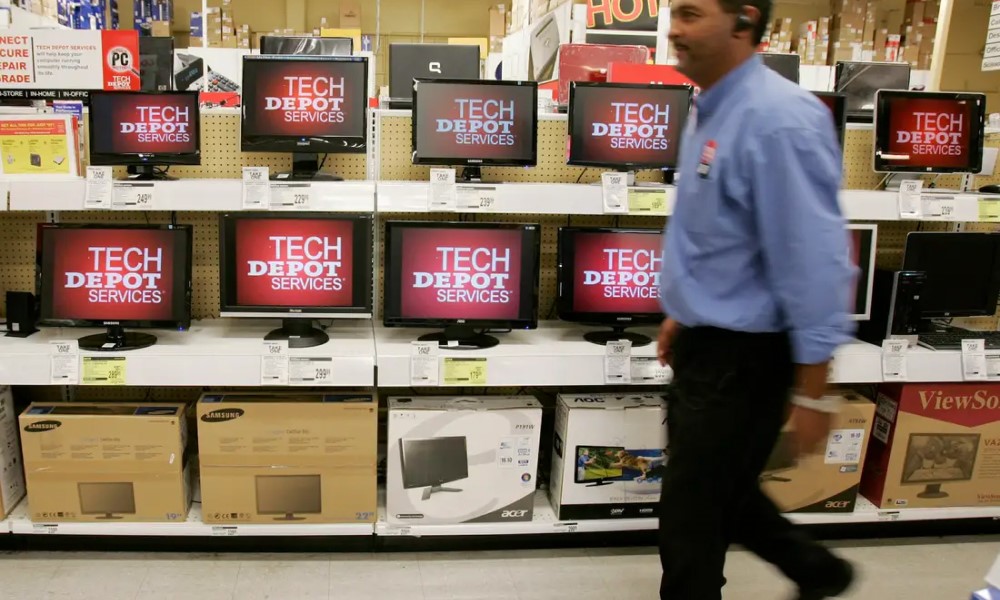 Office Depot staff walks in front of tech product space