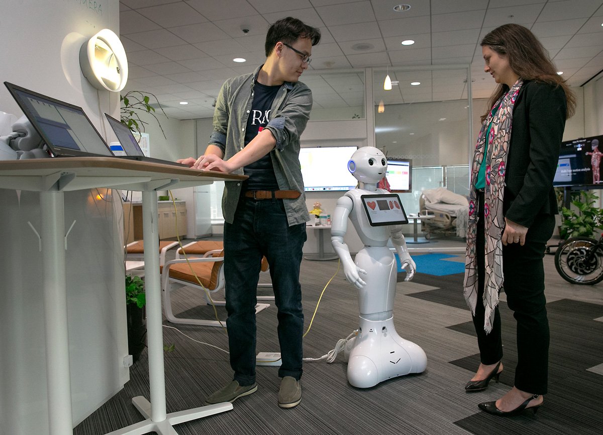 IBM staff work with Robot at IBM office