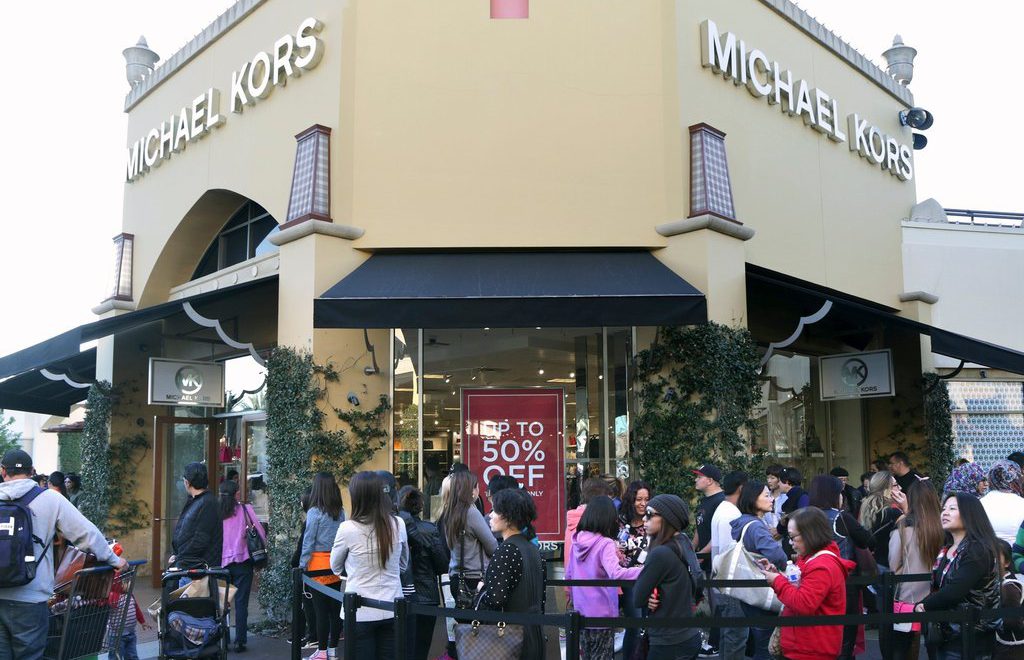 People is shopping at Michael Kors section in Brick and mortar store