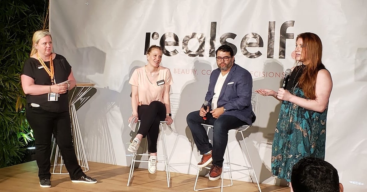 RealSelf staff shares stories in a conference