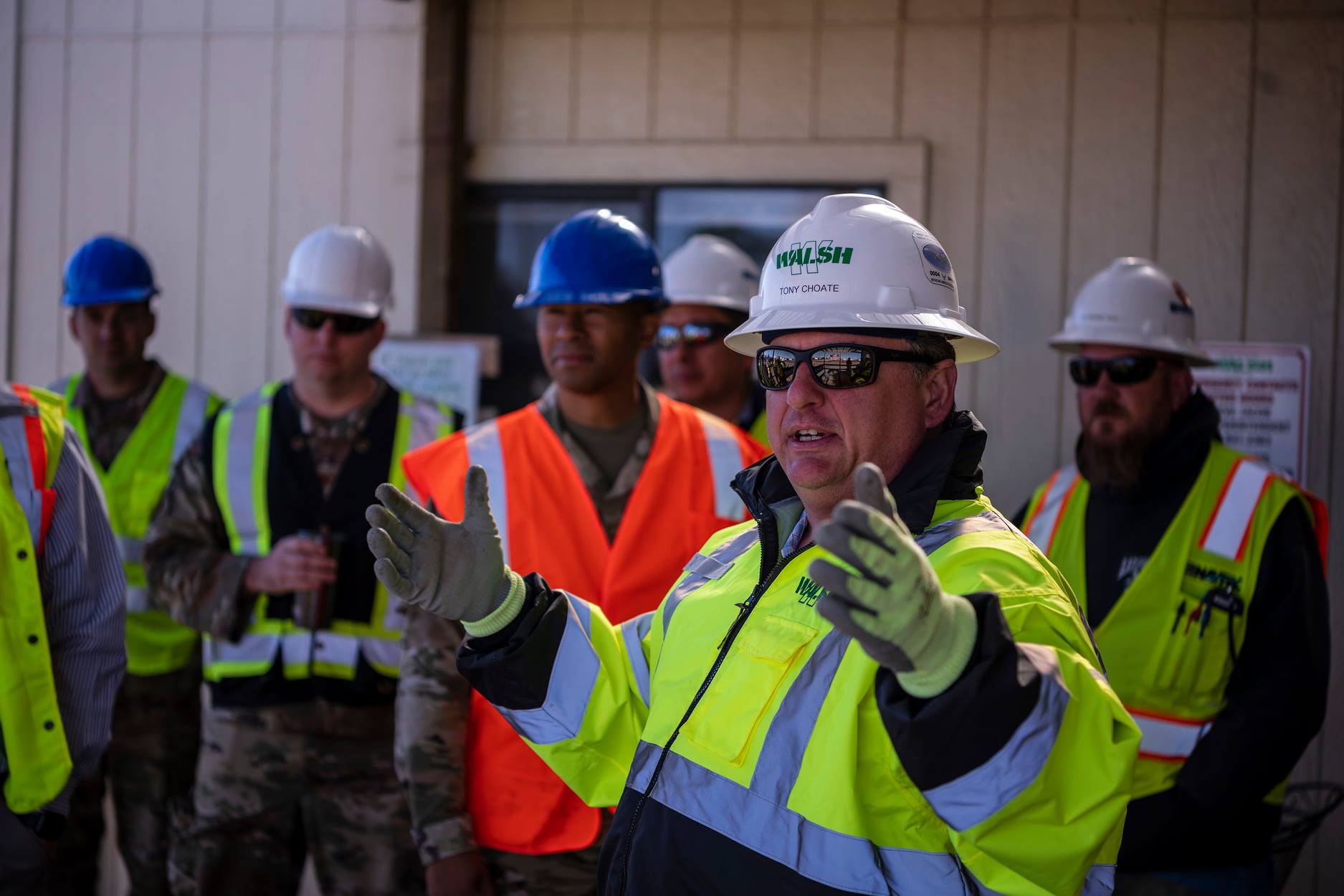 Project manager collaborate with front-line workers at job site